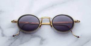 Jacques Marie Mage Varda | Ebony ovale Luxus-Sonnenbrille mit goldenem Rahmen und lila Gläsern