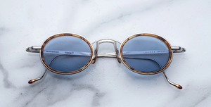 Jacques Marie Mage Varda Cairo ovale Luxus-Sonnebrille mit silbernem Rahmen und blauen Gläsern