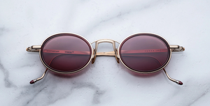 Jacques Marie Mage Varda Champagne ovale Luxus-Sonnenbrille mit goldenem Rahmen und roten Gläsern