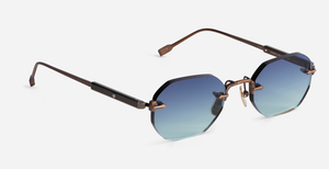 Randlose Sonnenbrille in Blau–Türkis Gradient, gezeigt aus schräger Seitenperspektive mit bronzefarbenen Bügeln