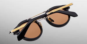 jacques marie mage hudson noirx runde sonnenbrille in schwarz und silber mit orangen gläsern