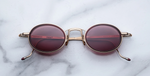 Jacques Marie Mage Varda Champagne ovale Luxus-Sonnenbrille mit goldenem Rahmen und roten Gläsern