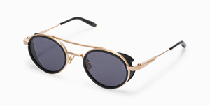 akoni astria matte black ovale sonnenbrille in matt schwarz und gold mit grauen gläsern