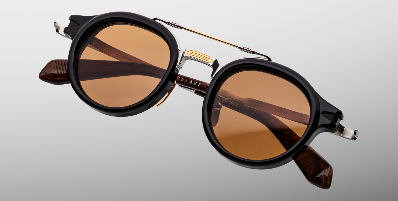 jacques marie mage hudson noirx runde sonnenbrille in schwarz und silber mit orangen gläsern