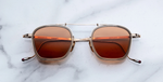 jacques marie mage baudelaire 2 darjeeling eckige sonnenbrille aus titan und acetat in gold und taupe mit orangenen gläsern