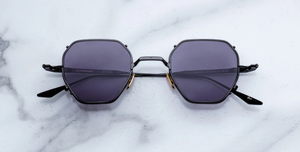 jacques marie mage verlaine corbeau titansonnenbrille in schwarz und silber mit grauen gläsern