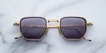 jacques marie mage atkins gold eckige sonnenbrille in gold und schwarz mit violetten gläsern