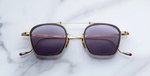 jacques marie mage baudelaire 2 ebony eckige sonnenbrille aus titan und acetat in gold und schwarz marmoriert mit grau blauen gläsern