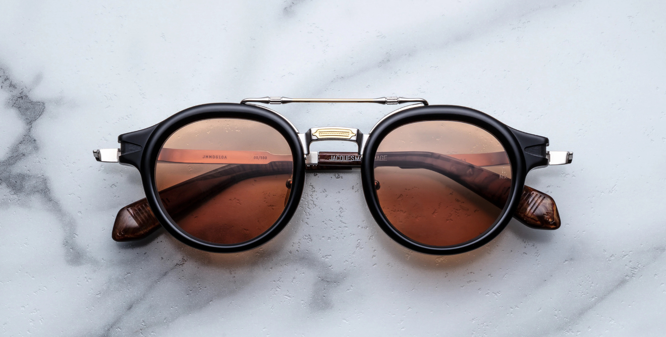 jacques marie mage hudson noirx runde sonnenbrille in schwarz und silber mit orangen gläsern