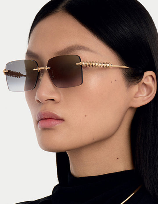 model wearing gold sunglasses