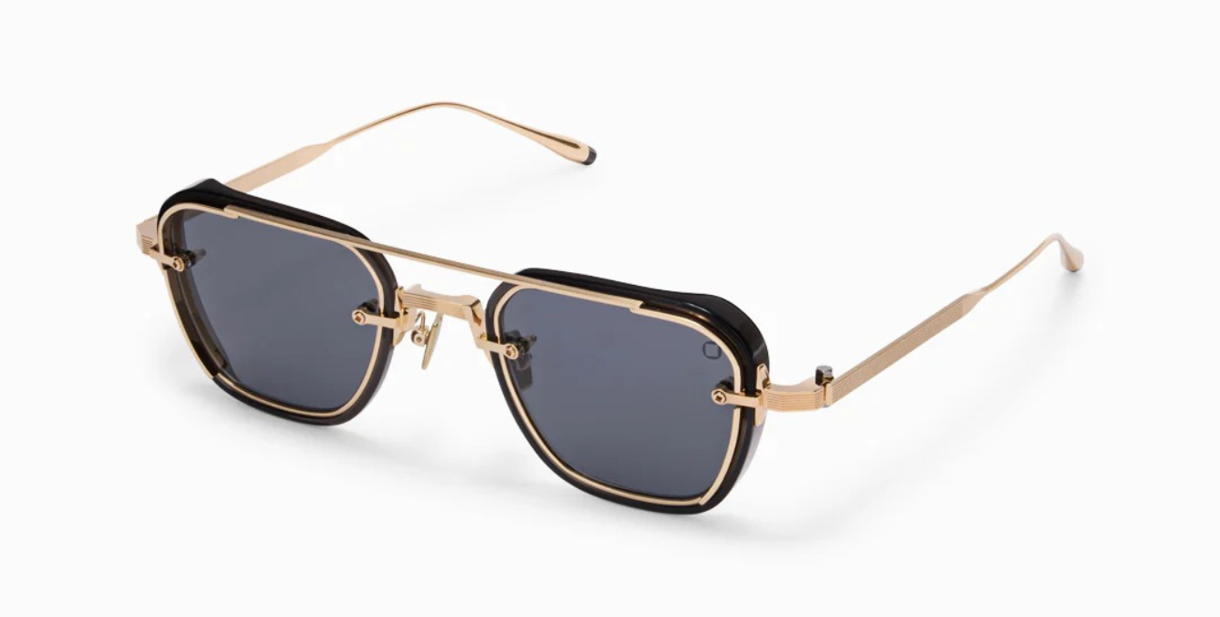 akoni jura crystal black ckige sonnenbrille in schwarz und gold mit grauen gläsern