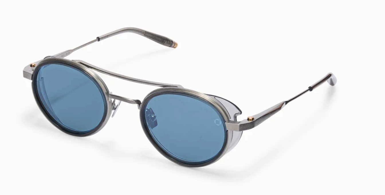 akoni astria crystal grey ovale sonnenbrille aus titan und acetat in silber und grau mit blauen verspiegelten gläsern