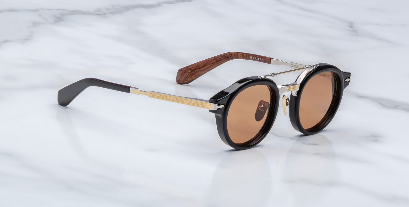 jacques marie mage hudson noirx runde sonnenbrille in schwarz und silber mit orangen gläsern